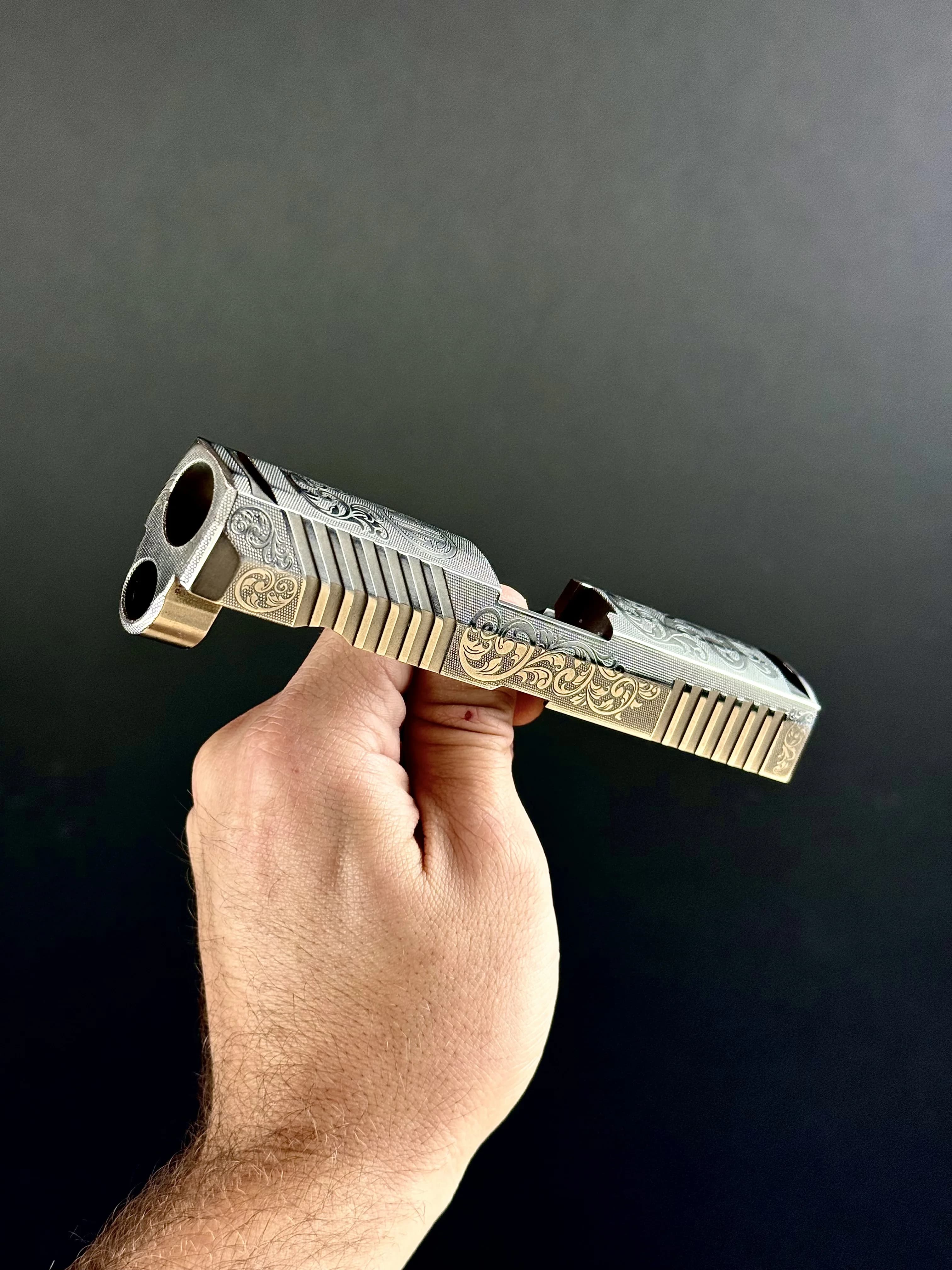 Custom engraved Glock 19 slide featuring geometric pattern design